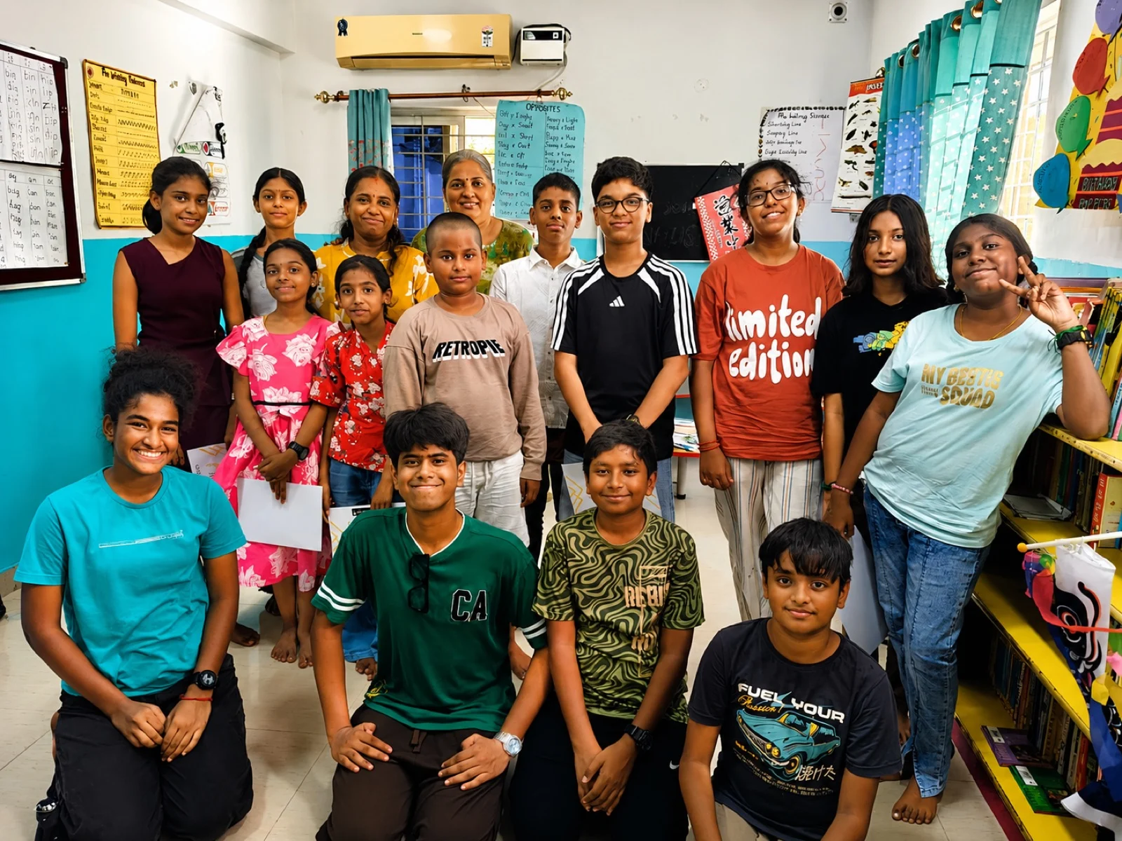 A group of women teachers and students posing indoors together